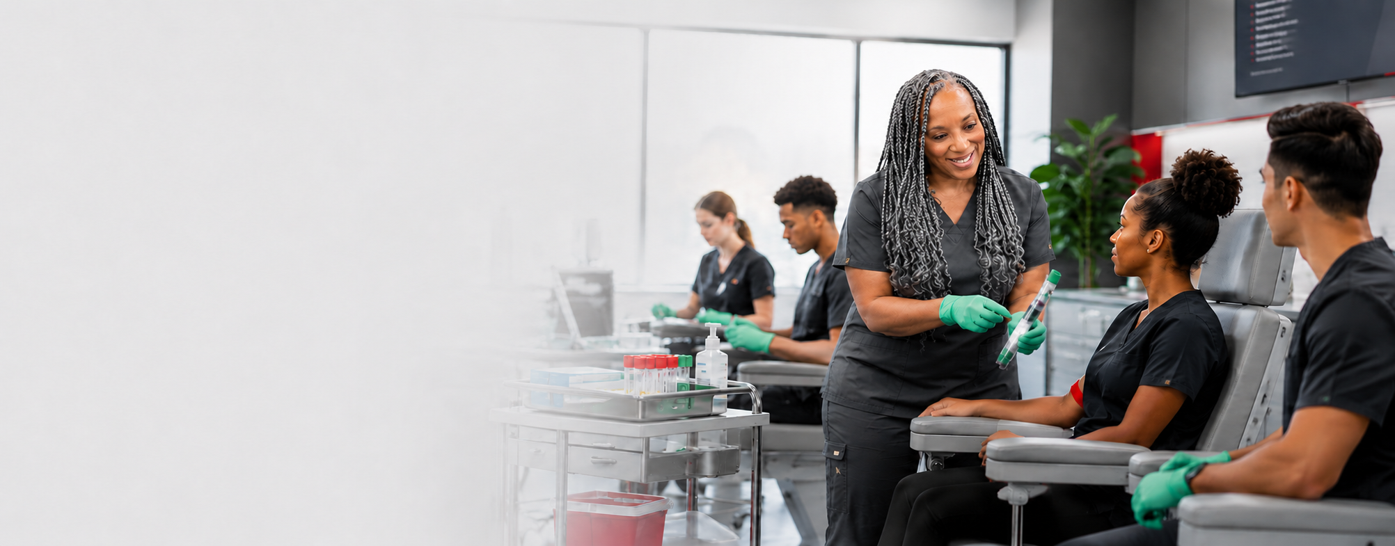 Adult students receiving hands-on healthcare training in a modern clinical classroom